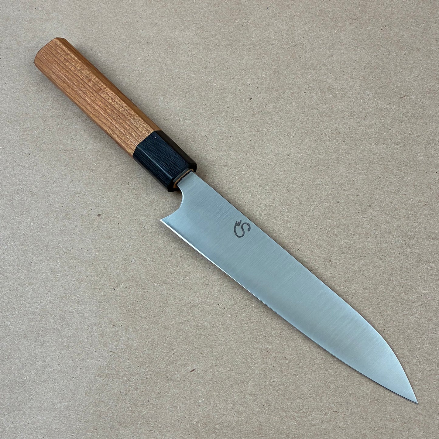 Knife with a wooden handle on a beige background