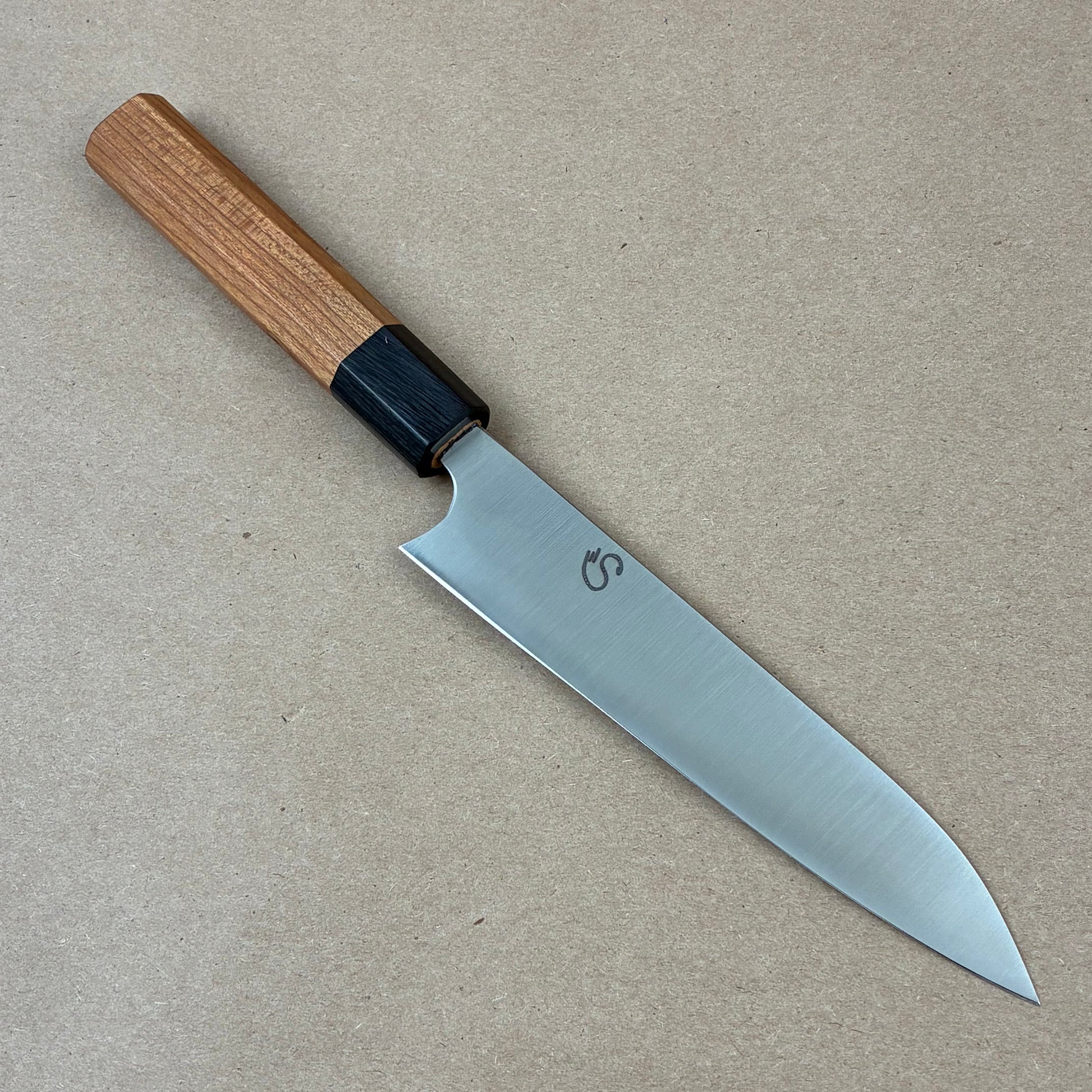 Knife with a wooden handle on a beige background