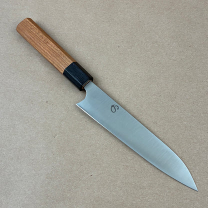 Knife with a wooden handle on a beige background