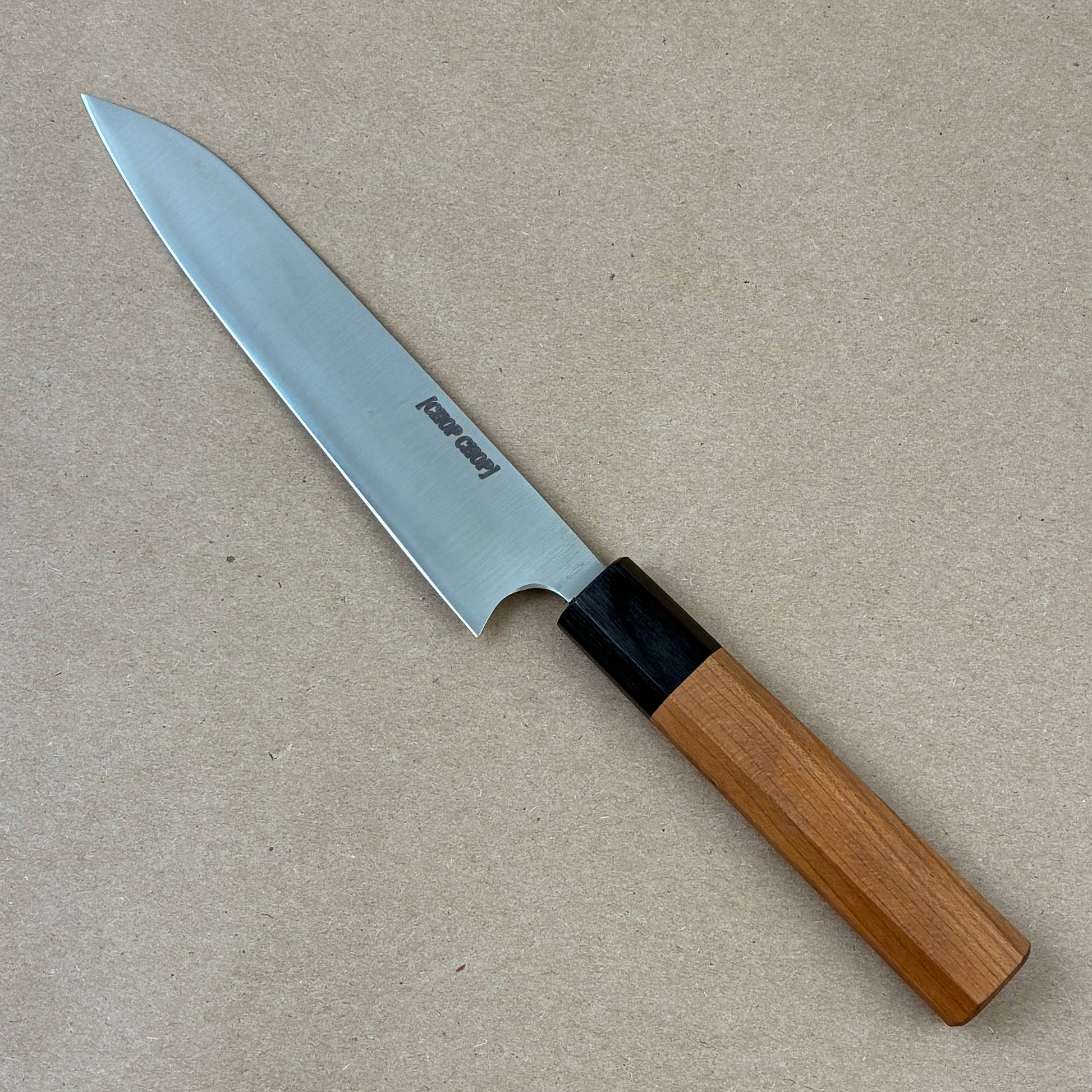 Knife with a wooden handle on a beige background