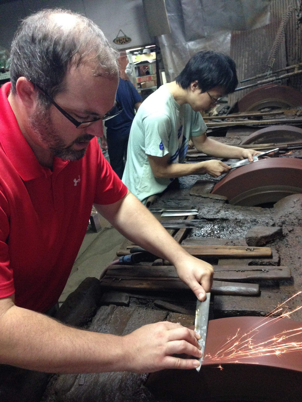 Derek on the grinding wheel at Shiraki Hamono