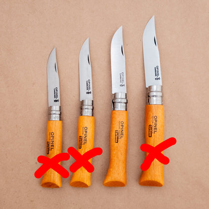 Four Opinel knives with orange handles on a brown background